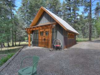 Discover this charming cabin nestled amongst tall pine trees, offering a serene retreat.