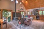 Experience rustic charm in this open-concept living space, featuring a striking wood-burning stove as the focal point.