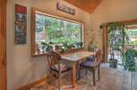 Enjoy a charming breakfast nook with a large window offering picturesque views of the lush greenery outside.