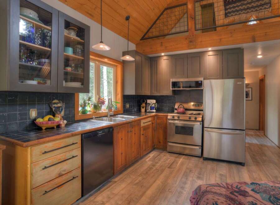 This charming kitchen boasts rustic wooden floors and exposed beams, creating a warm and inviting atmosphere.