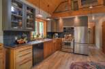 This charming kitchen boasts rustic wooden floors and exposed beams, creating a warm and inviting atmosphere.