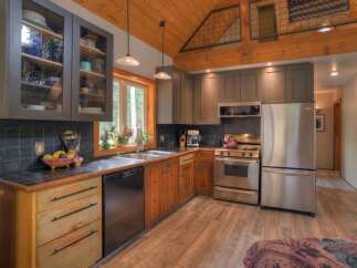 This charming kitchen boasts rustic wooden floors and exposed beams, creating a warm and inviting atmosphere.