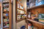 Discover a well-organized pantry, showcasing a variety of organic foods, canned goods, and health supplements.
