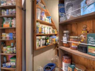 Discover a well-organized pantry, showcasing a variety of organic foods, canned goods, and health supplements.