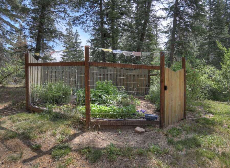 Discover a charming fenced garden, perfect for cultivating your own vegetables and herbs.