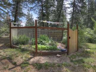 Discover a charming fenced garden, perfect for cultivating your own vegetables and herbs.