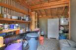 This spacious shed offers ample storage solutions with its sturdy shelving units, perfect for organizing tools and supplies.