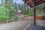Discover this charming property featuring a rustic wooden gate leading to a serene backyard oasis.