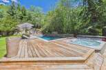 Escape to this luxurious backyard oasis featuring a sparkling swimming pool and a relaxing hot tub, perfect for unwinding.