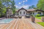 Experience luxurious outdoor living with this stunning backyard oasis, featuring a spacious wooden deck perfect for entertaining.