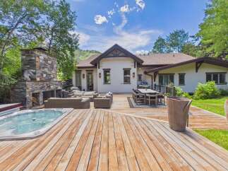 Experience luxurious outdoor living with this stunning backyard oasis, featuring a spacious wooden deck perfect for entertaining.