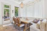 Experience rustic charm in this dining area featuring a live-edge wooden table and unique antler chairs.
