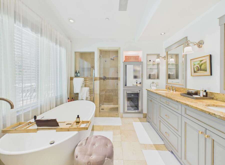 Indulge in luxury with this stunning bathroom featuring a freestanding soaking tub and a spacious walk-in shower with elegant tilework.