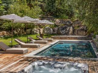 Experience ultimate relaxation in this luxurious backyard oasis, featuring a sparkling swimming pool and a bubbling hot tub perfect for unwinding.