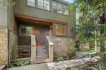 This charming property features a rustic stone exterior complemented by warm wooden accents and a welcoming entrance.