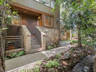 Nestled beside a serene creek and surrounded by lush trees, this property offers a unique blend of modern living and natural beauty.