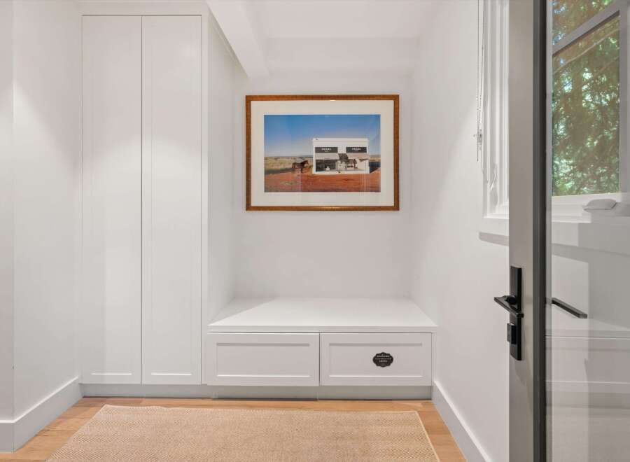 This entryway features a built-in bench with storage drawers, perfect for organizing shoes and accessories.