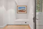 This entryway features a built-in bench with storage drawers, perfect for organizing shoes and accessories.