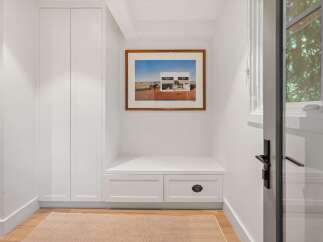 This entryway features a built-in bench with storage drawers, perfect for organizing shoes and accessories.