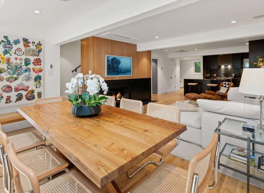 Experience modern living in this open-concept space featuring a stunning live-edge dining table perfect for gatherings.