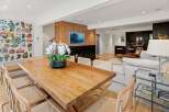 Experience modern living in this open-concept space featuring a stunning live-edge dining table perfect for gatherings.