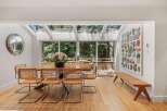 This dining room boasts a stunning wooden dining table surrounded by elegant cane-backed chairs, perfect for intimate gatherings.