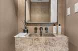 Elevate your bathroom with this stunning vanity featuring a unique marble countertop and a modern wall-mounted faucet.