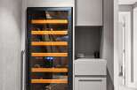 This modern home features a sleek wine cooler integrated into custom cabinetry, perfect for wine enthusiasts.