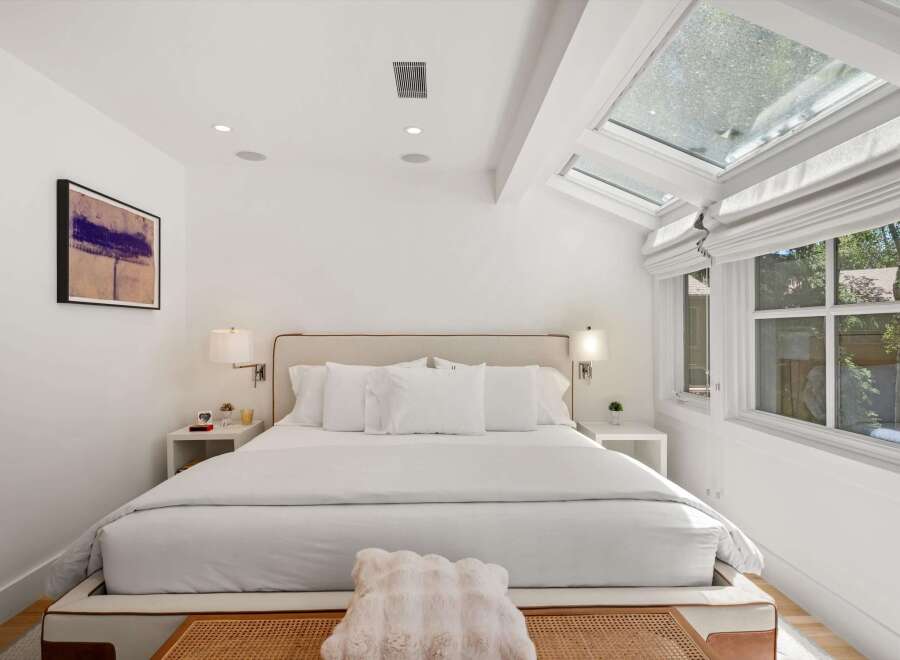 Experience luxurious comfort in this stunning bedroom, featuring a plush king-sized bed adorned with crisp white linens.