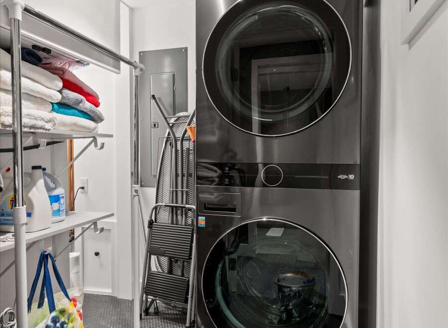 Discover a modern and efficient laundry space featuring a sleek, stacked LG ThinQ washer and dryer set.