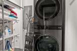 Discover a modern and efficient laundry space featuring a sleek, stacked LG ThinQ washer and dryer set.
