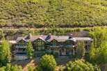 Experience luxury mountain living in this stunning estate, nestled against a verdant hillside.