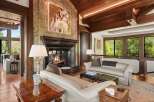 Experience luxury living in this stunning living room, featuring a grand marble fireplace and a captivating abstract artwork.