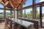 Experience breathtaking mountain views from this stunning bar area, featuring a granite countertop and comfortable seating.