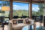 Experience breathtaking mountain views from this luxurious living space, featuring expansive windows that frame a stunning landscape.