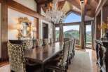 Experience luxurious dining with this stunning formal dining room, featuring a grand crystal chandelier and a large, ornate wooden table perfect for hosting.