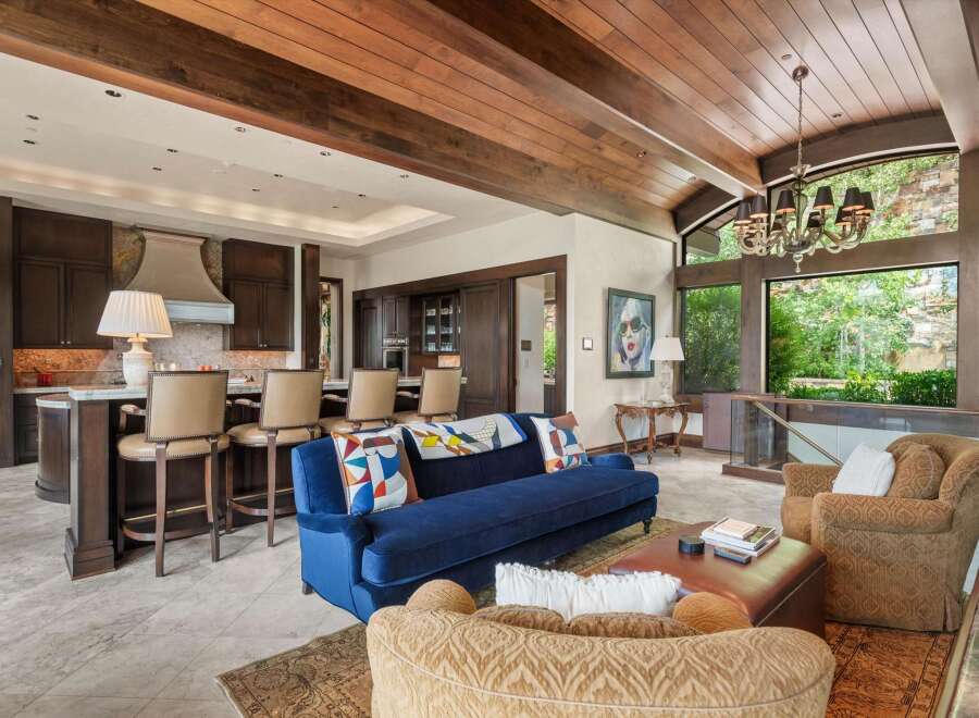 Experience luxurious living in this stunning open-concept great room, featuring a gourmet kitchen with a large island and bar seating, perfect for entertaining.