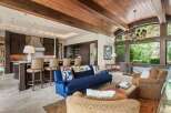 Experience luxurious living in this stunning open-concept great room, featuring a gourmet kitchen with a large island and bar seating, perfect for entertaining.