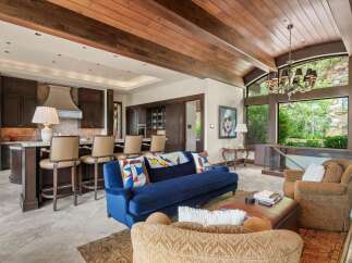Experience luxurious living in this stunning open-concept great room, featuring a gourmet kitchen with a large island and bar seating, perfect for entertaining.