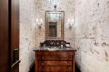 Experience luxury in this powder room featuring a stunning marble vanity with a dark wood cabinet base.