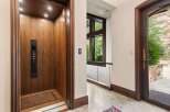 Experience seamless living with this elegant elevator, featuring rich wood paneling and modern controls.