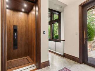 Experience seamless living with this elegant elevator, featuring rich wood paneling and modern controls.