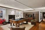 Experience ultimate entertainment in this luxurious game room, featuring a custom roulette table and a large flat-screen TV.