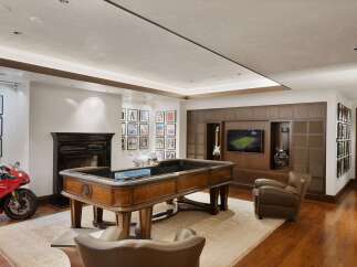 Experience ultimate entertainment in this luxurious game room, featuring a custom roulette table and a large flat-screen TV.