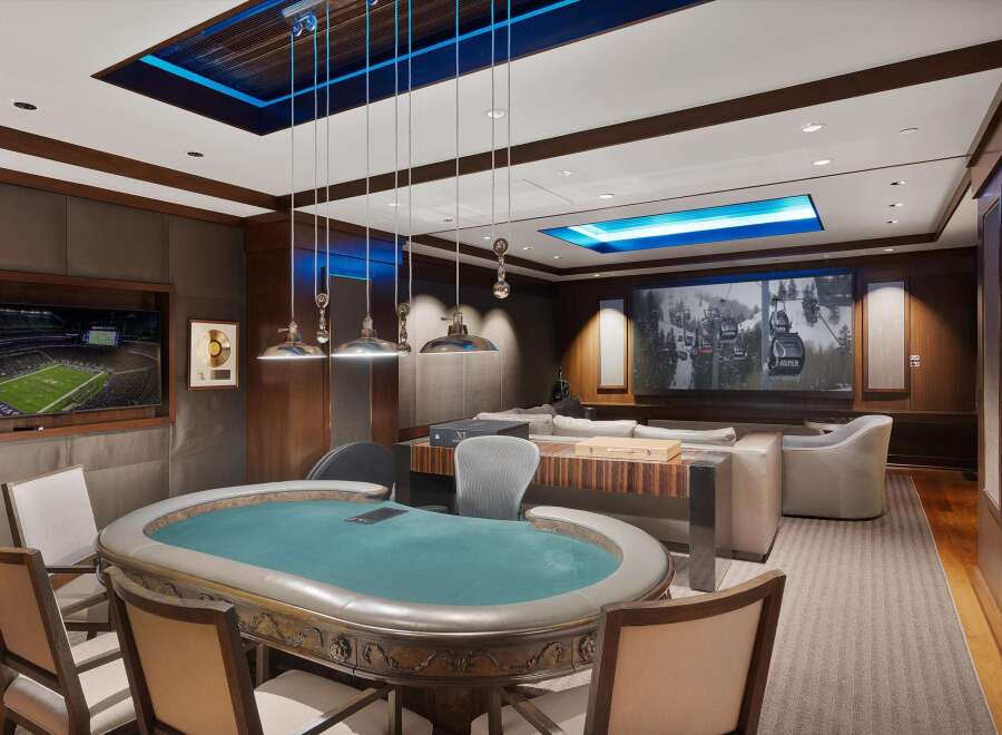Experience ultimate entertainment in this luxurious game room, featuring a professional poker table and a large screen for watching sports or movies.