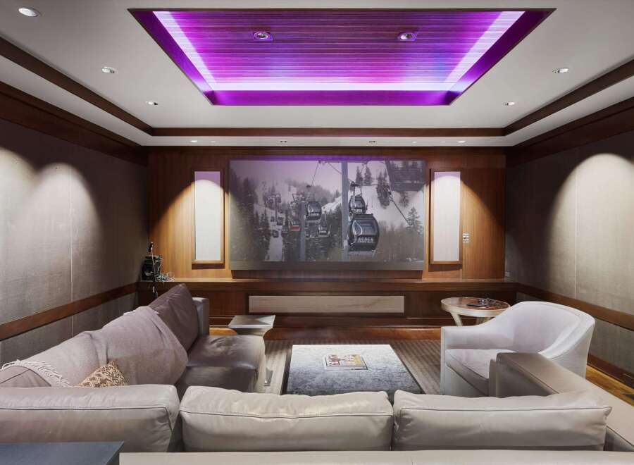 Experience cinematic luxury in this stunning home theater, featuring a massive projection screen perfect for movie nights.