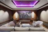 Experience cinematic luxury in this stunning home theater, featuring a massive projection screen perfect for movie nights.