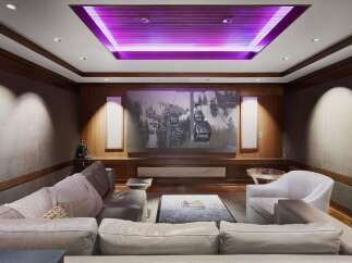 Experience cinematic luxury in this stunning home theater, featuring a massive projection screen perfect for movie nights.