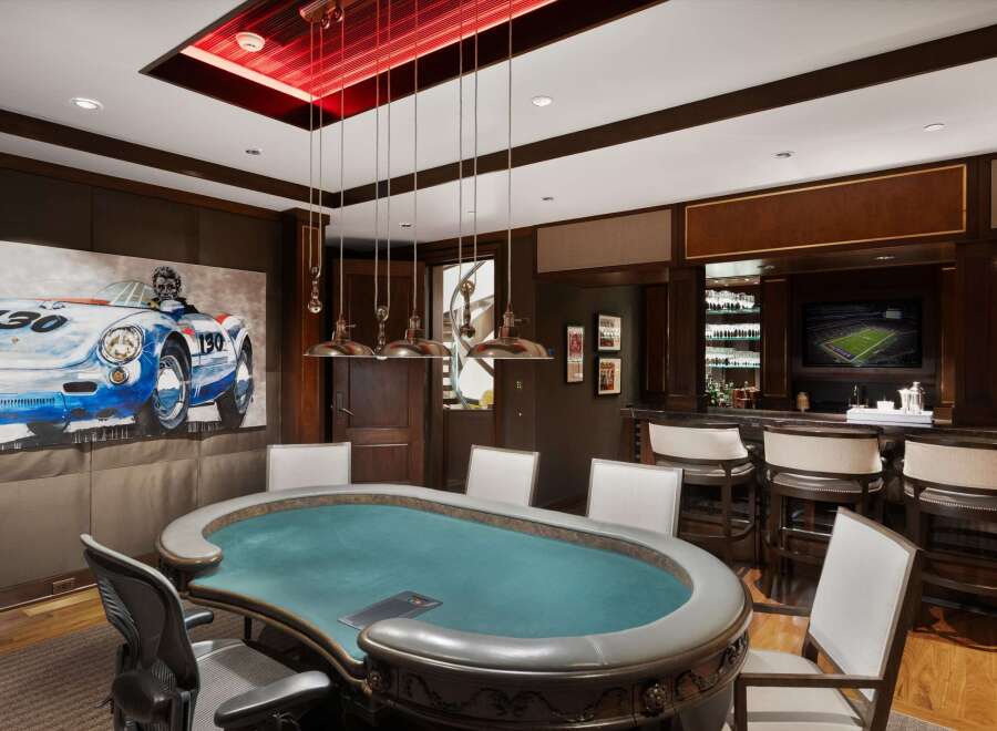 Experience ultimate entertainment in this luxurious game room, featuring a professional poker table and a fully equipped bar.
