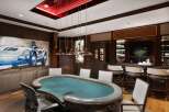 Experience ultimate entertainment in this luxurious game room, featuring a professional poker table and a fully equipped bar.